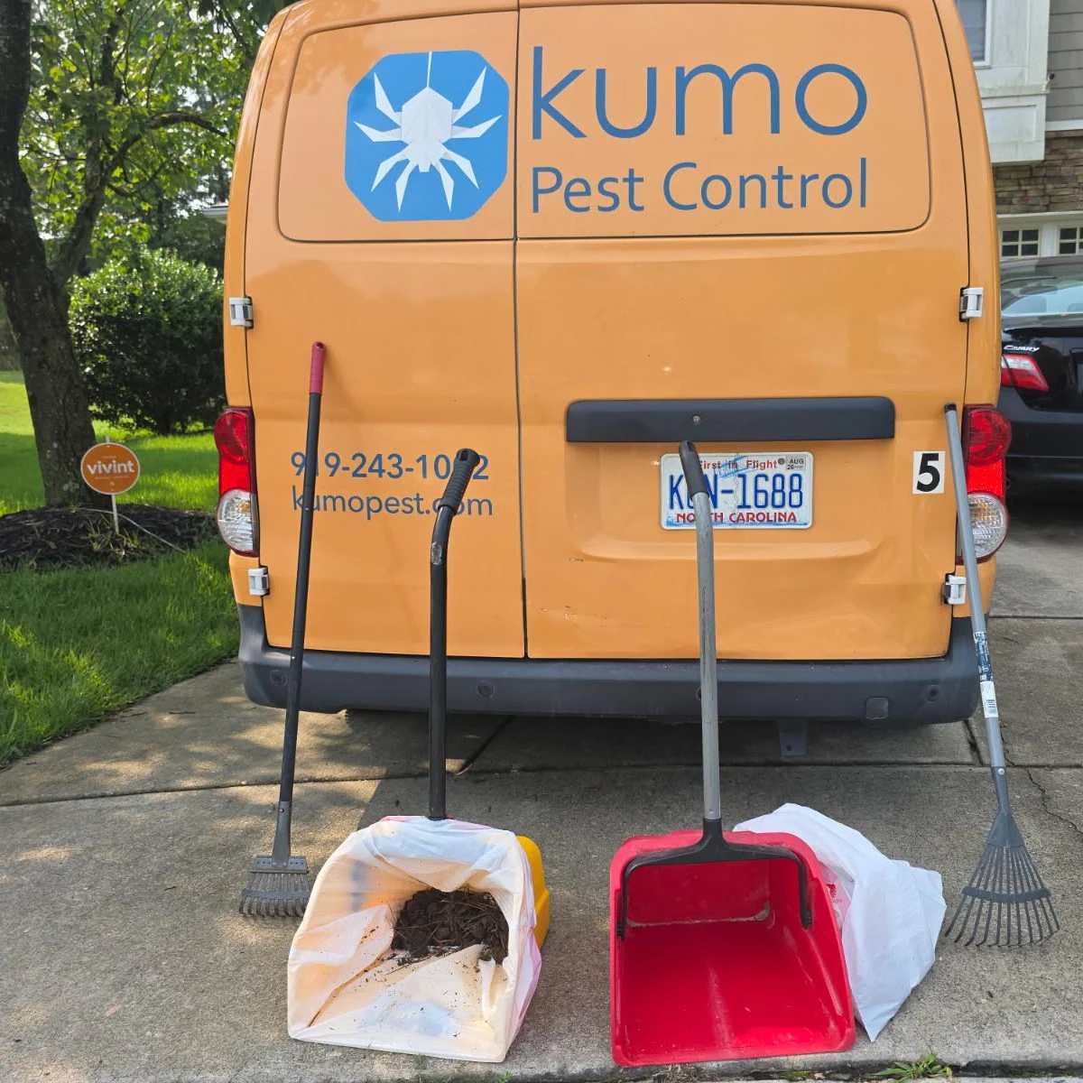 Kumo Pest Control vehicle and dog waste removal equipment at a residential service visit